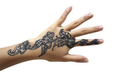 Black floral hand tattoo on upper hand for women
