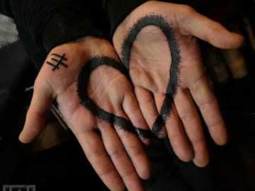 Black heart tattoo on both palms