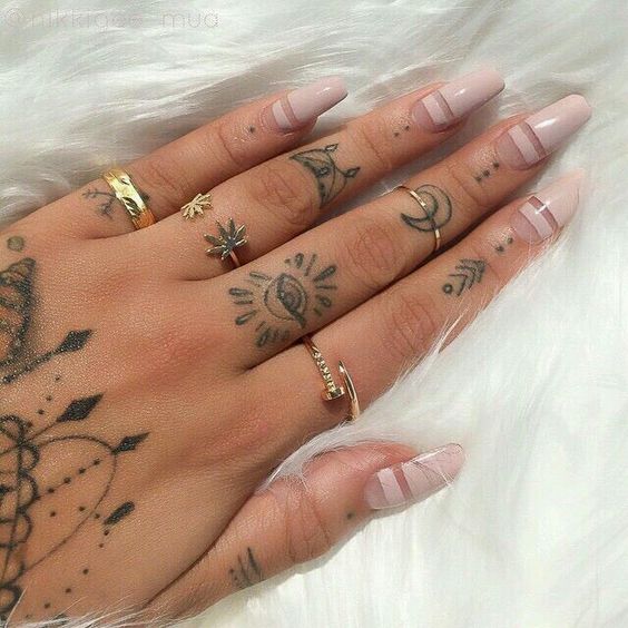 Black multiple elements tattoo on upper left hand for women