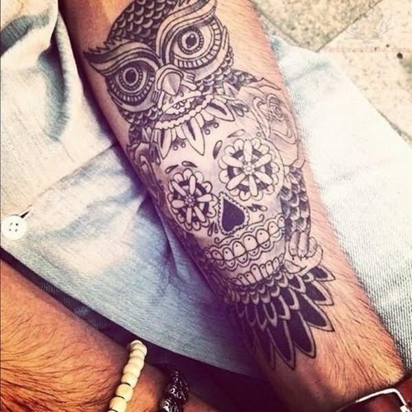 Black owl sugar skull tattoo design on upper forearm