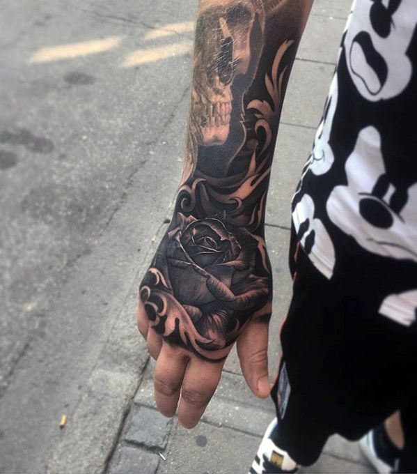 Black rose tattoo on upper right hand