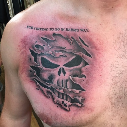 Black shaded skin cut punisher tattoo on upper right chest for men