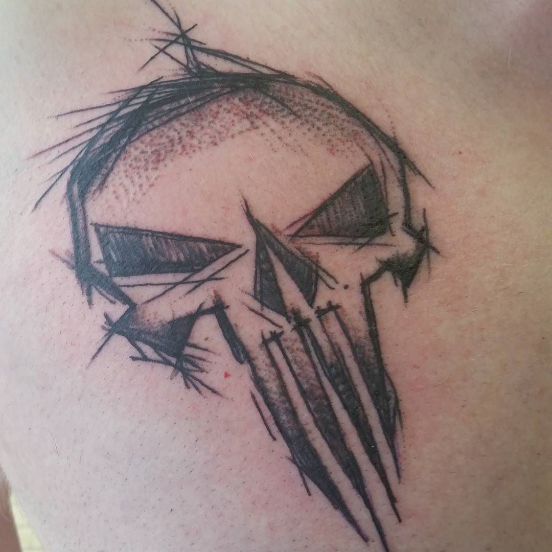Black sketched punisher skull tattoo on body