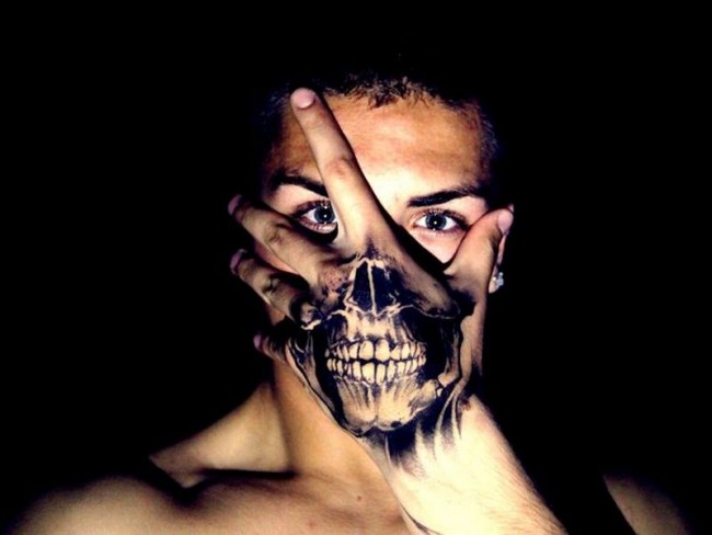 Black skull illusion tattoo on upper hand for men