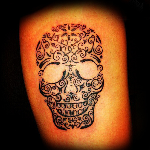 Black sugar skull tattoo design on arm