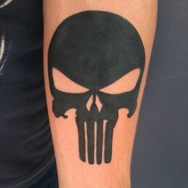 Black tribal punisher skull tattoo on arm for men