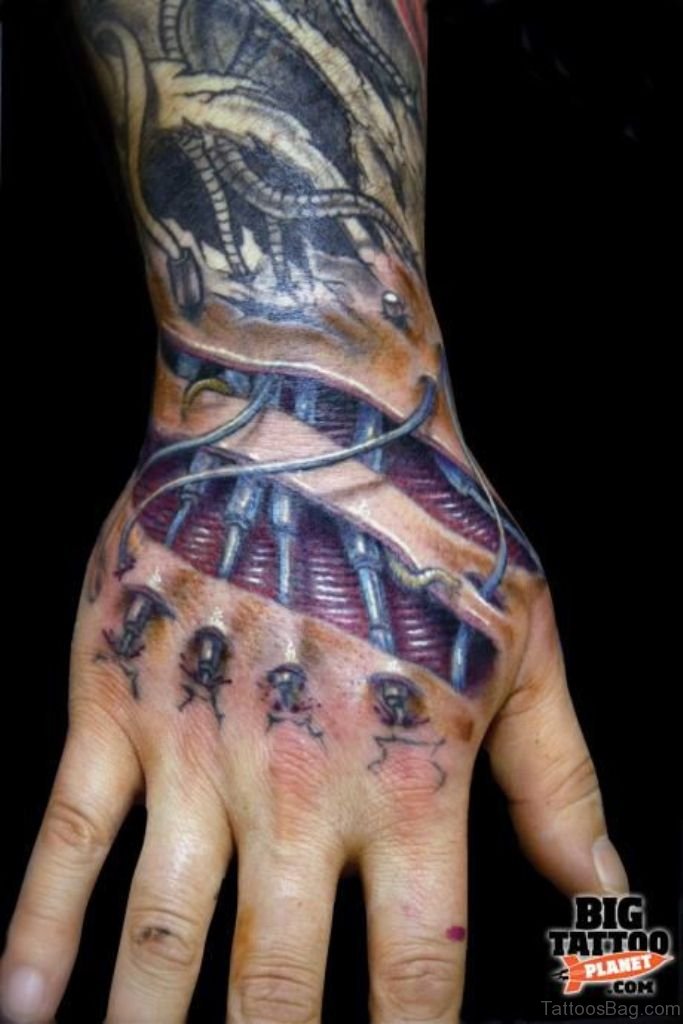 Colored bio mechanical tattoo on upper hand
