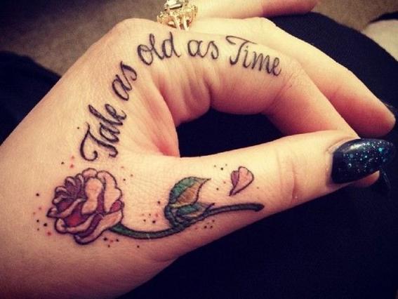 Colored rose tattoo on upper left thumb