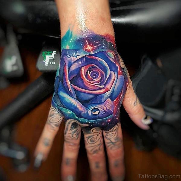 Colorful rose tattoo on upper hand