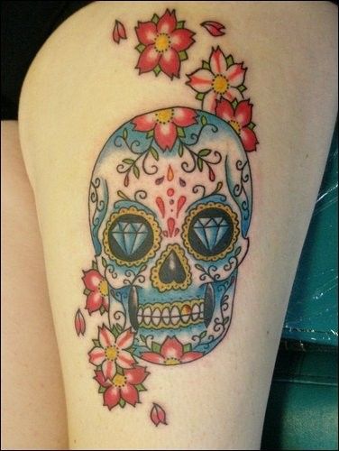 Colorful sugar skull with flowers tattoo on body