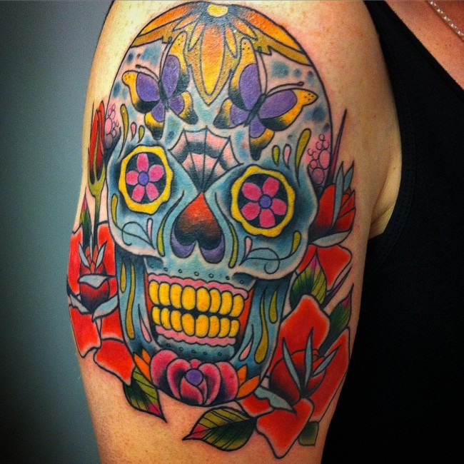 Colorful sugar skull with flowers tattoo on upper right arm