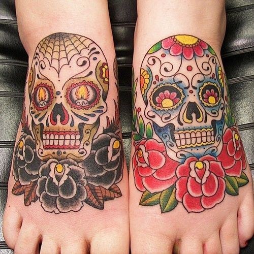 Colorful sugar skulls tattoo on feet
