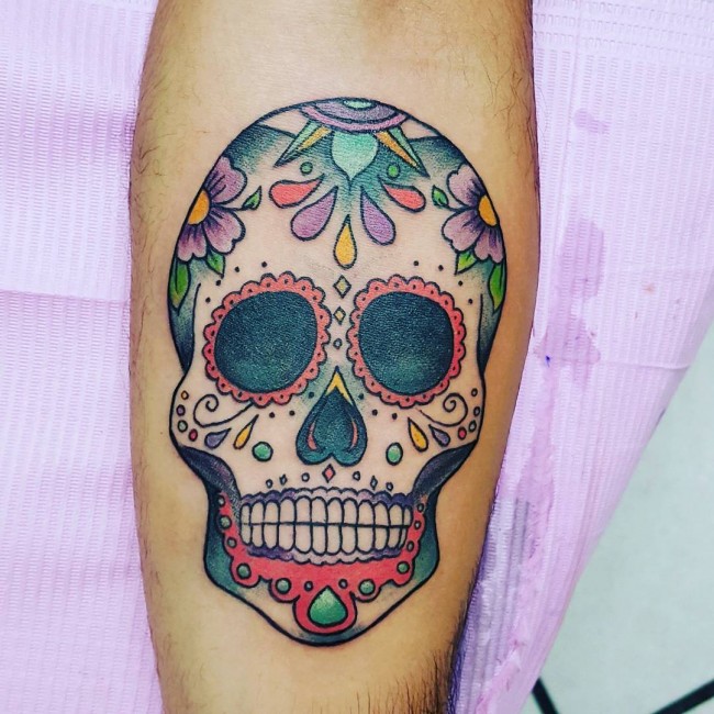 Colorful unisex sugar skull tattoo on body