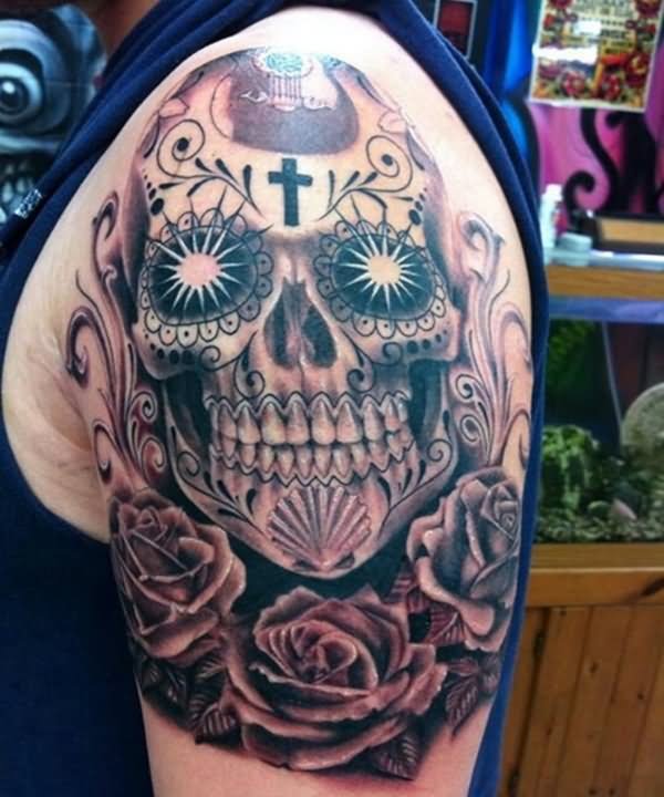 Grey and red shaded sugar skull and roses tattoo on upper arm