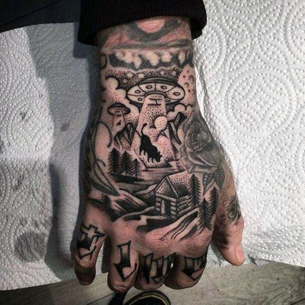 Grey shaded alien lion tattoo on upper hand