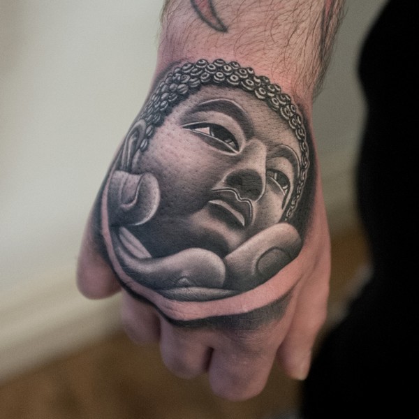 Grey shaded buddha tattoo on upper hand