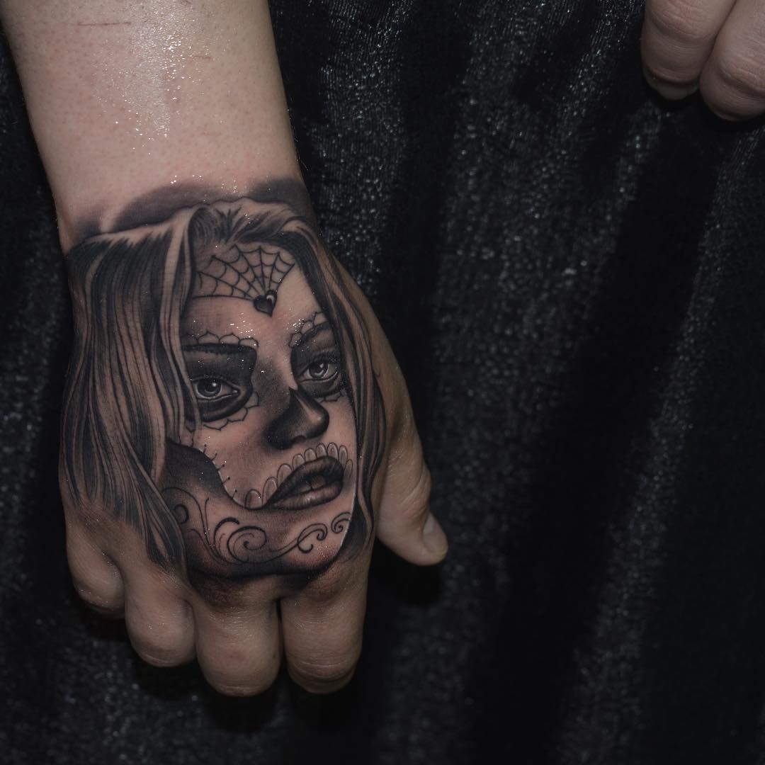 Grey shaded days of dead women tattoo on upper hand for women