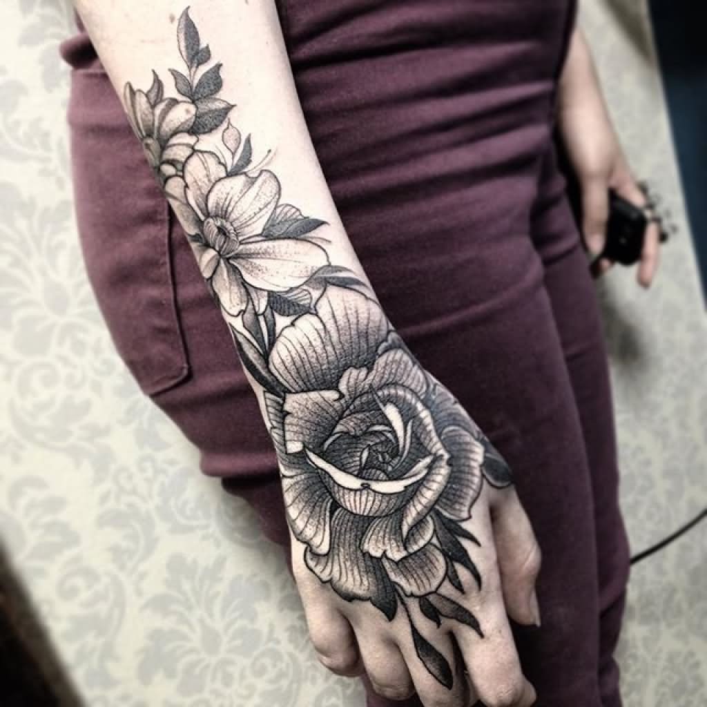 Grey shaded flower tattoo on upper hand for women