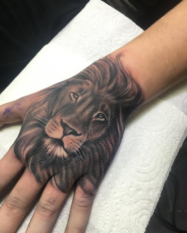 Grey shaded lion tattoo on upper hand