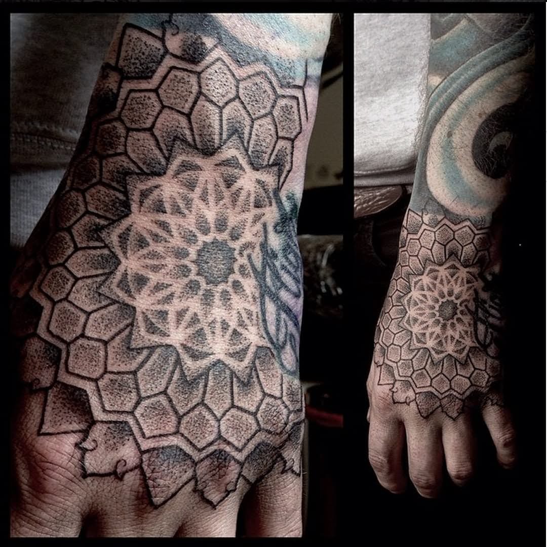 Grey shaded mandala flower tattoo design on upper hand