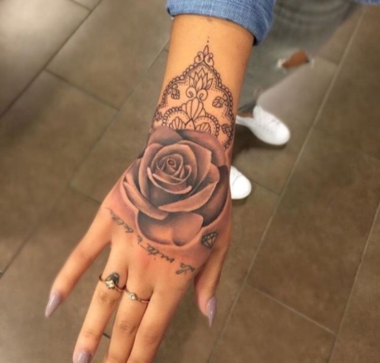 Grey shaded rose tattoo design on upper right hand