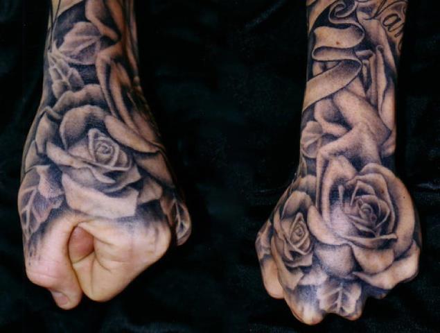 Grey shaded rose tattoo on upper hand