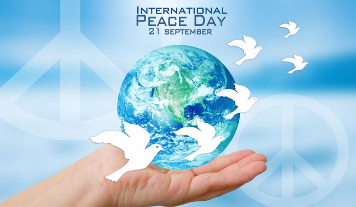 International peace day 21 september globe on hand