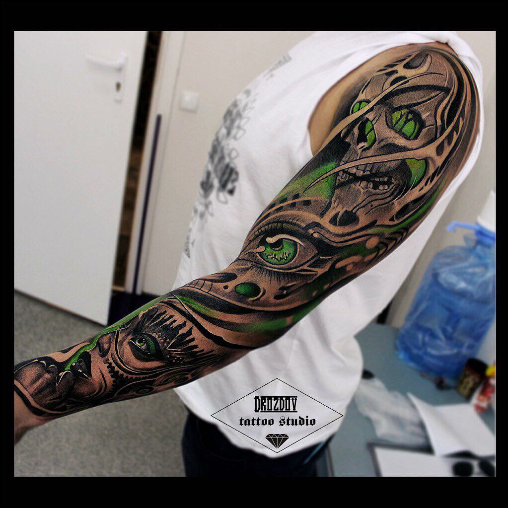 Black and green shaded skull tattoo on left full sleeve for men