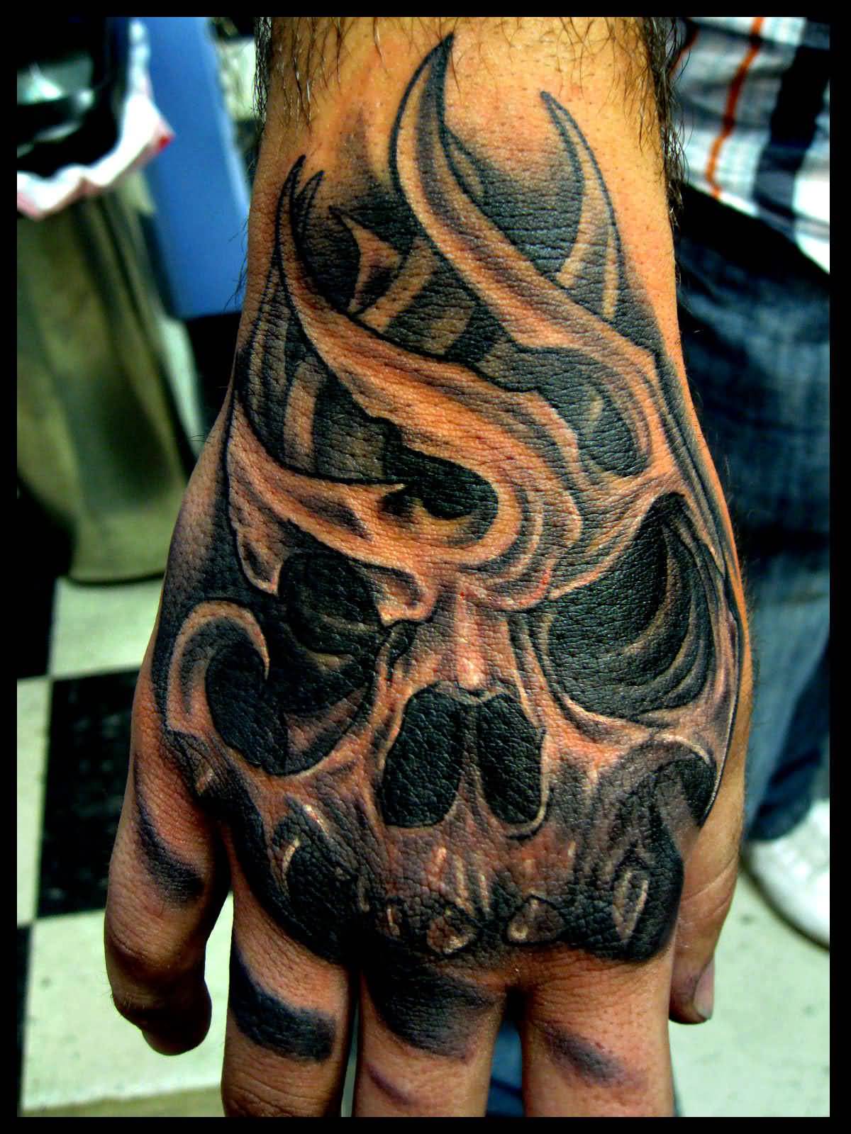 Black and grey shaded skull hand tattoo