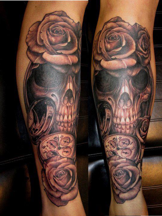 Black and grey shaded skulla nd roses tattoo on body
