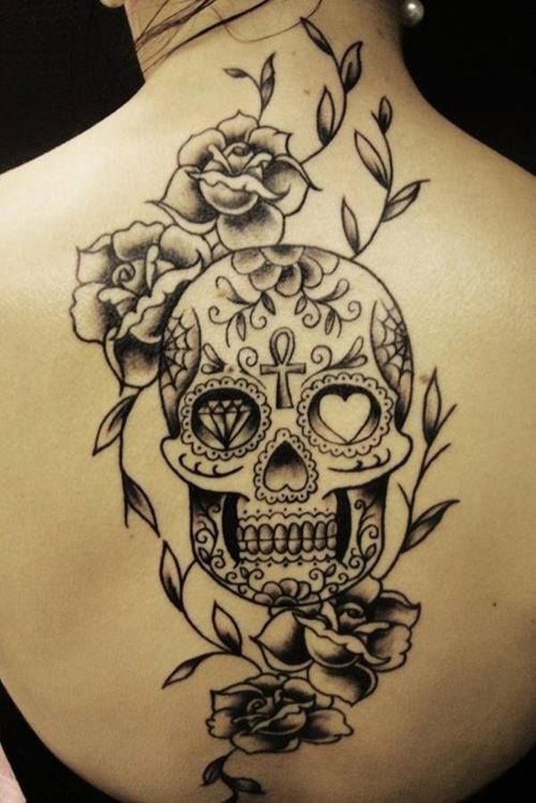 Black and grey sugar skull and roses tattoo on upper mid back