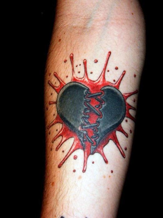 Black and red sewed broken heart tattoo on mid inner forearm