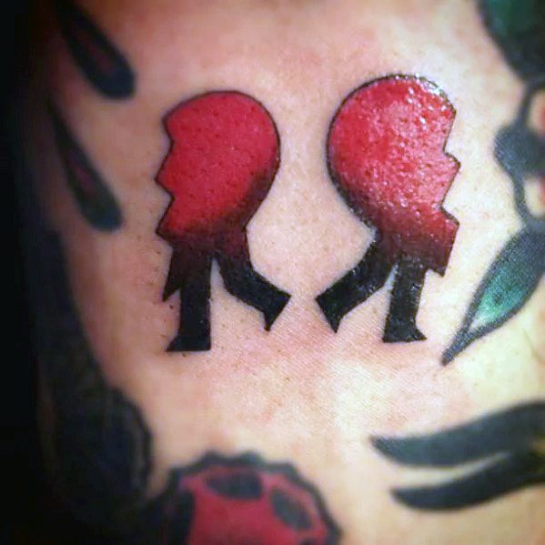 Black and red shaded two halves broken heart tattoo on body