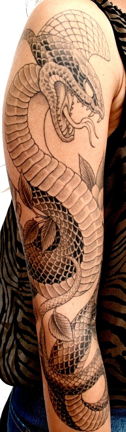 Black dragon and snake tattoo on full right arm of man