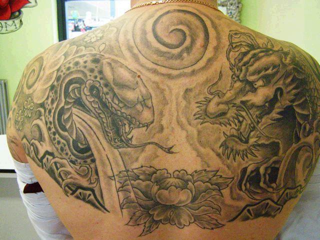 Black dragon and snake tattoo on full upper back