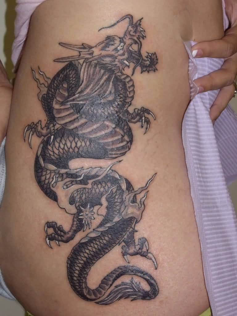 Black dragon and snake tattoo on siderib for women