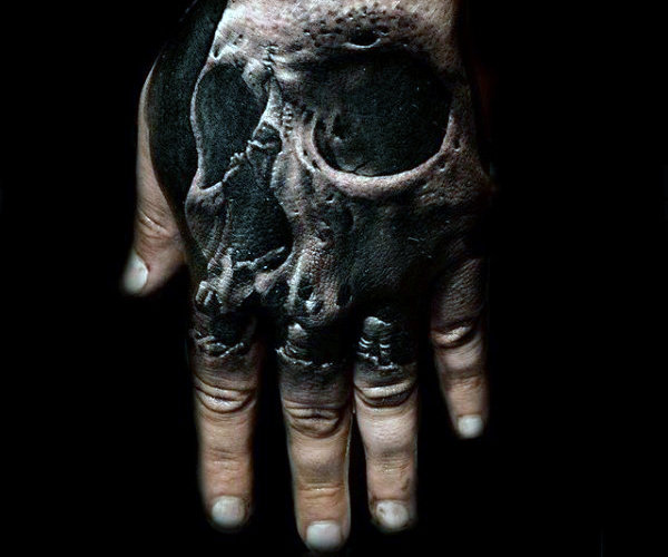 Black shaded 3d skull tattoo on hand for men