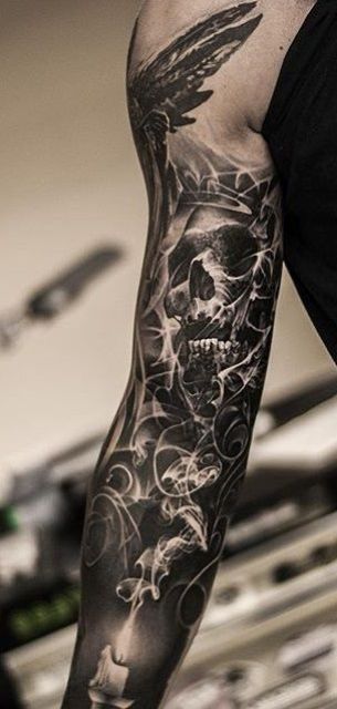 Black shaded skull tattoo on sleeve
