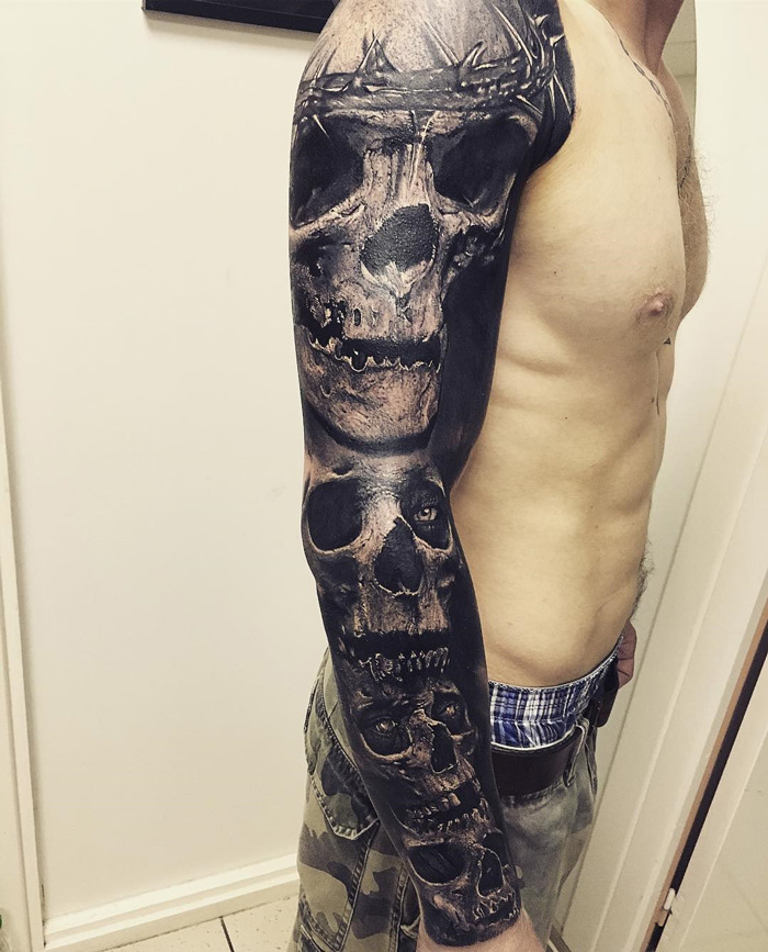 Black shaded skulls tattoo on right full sleeve for men
