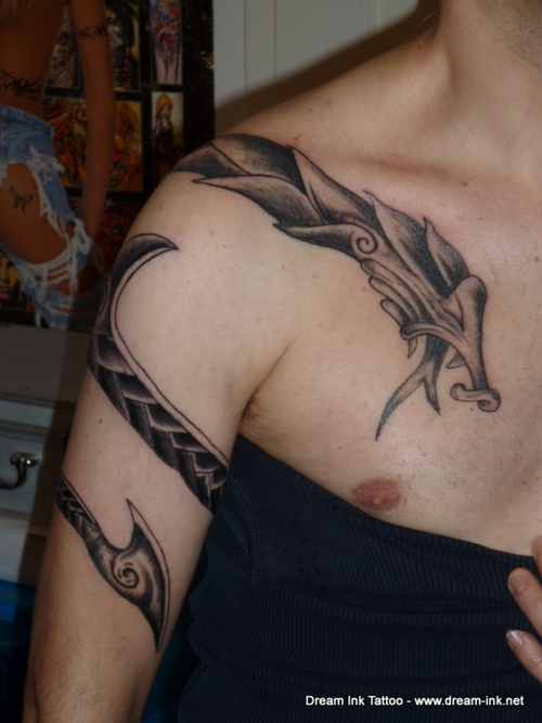 Black spiral dragon snake tattoo on right arm and shoulder