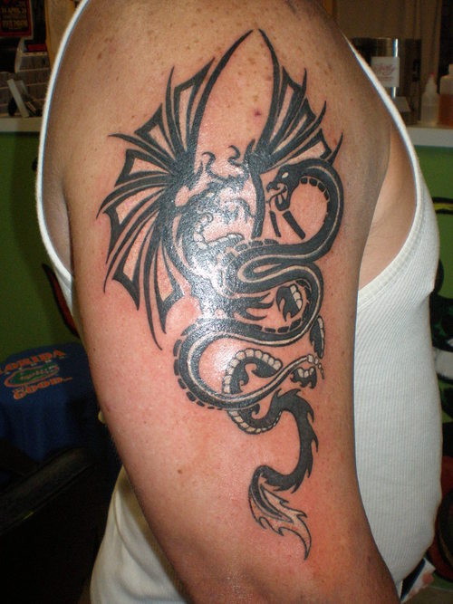 Black tribal dragon and snake tattoo on right upper arm