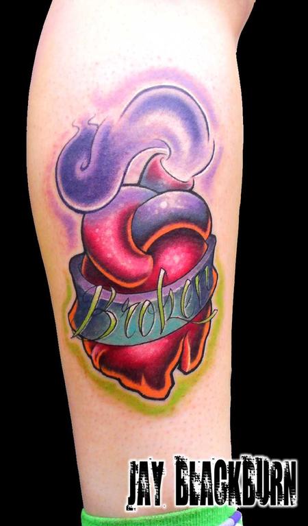 Colored broken heart tattoo on body for men