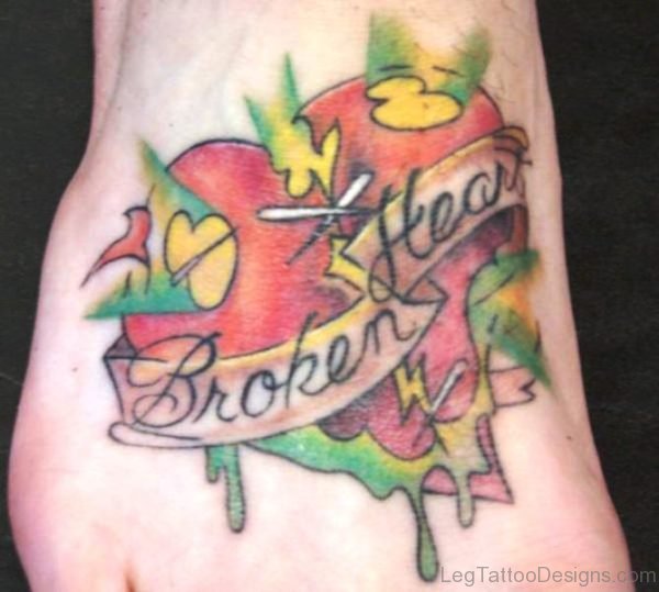 Colored broken heart tattoo on leg
