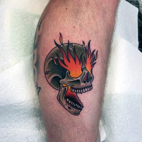 Colored fire eyes traditional skull tattoo on body