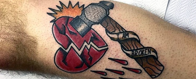Colored hammer broken heart tattoo on inner forearm for men