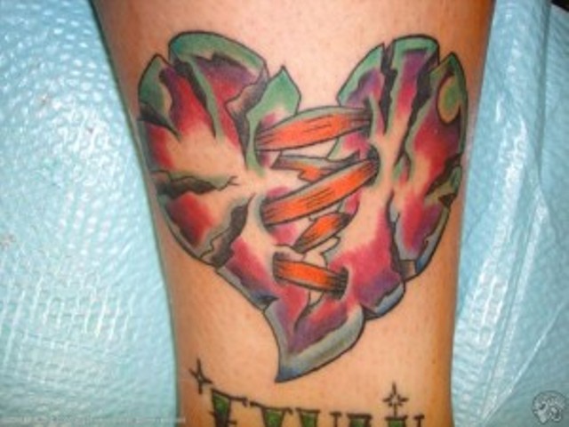 Colored sewed broken heart tattoo on arm