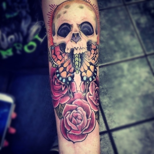 Colored skull with roses and butterfly tattoo on forearm