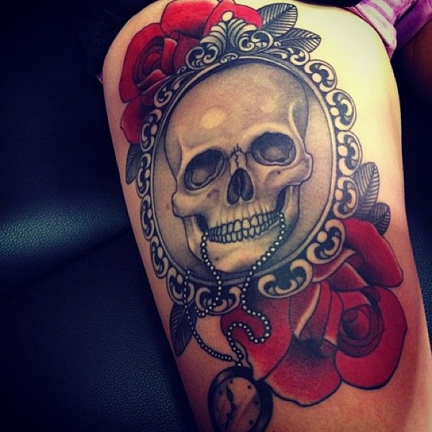 Colored skull with roses tattoo on right thigh