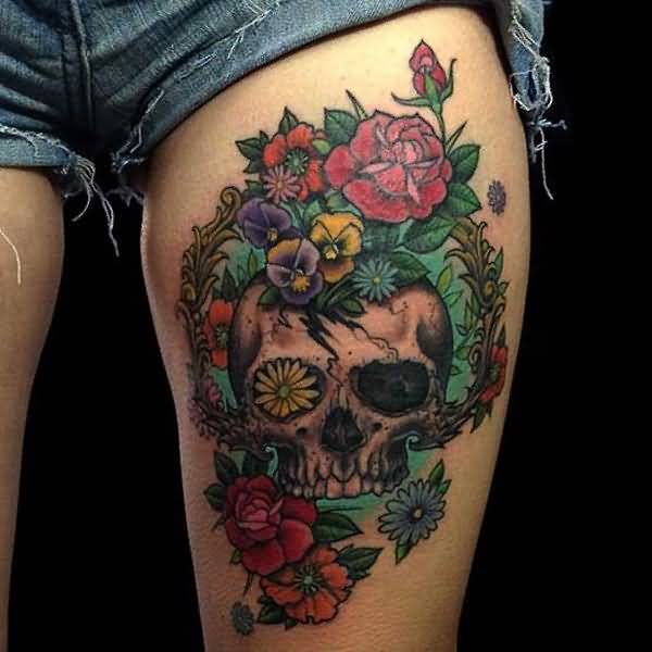 Colored skulla and roses tattoo on left thigh for women