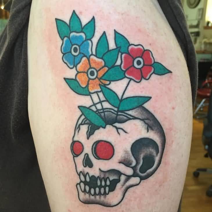 Colored traditional skull with flowers tattoo on body